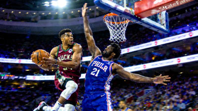 NBA常规赛雄鹿对阵76人比赛中，字母哥突破恩比德防守上篮